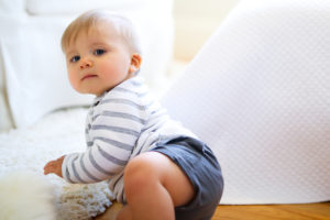 studio wardrobe: baby in shorts and striped sweater, in photo session.