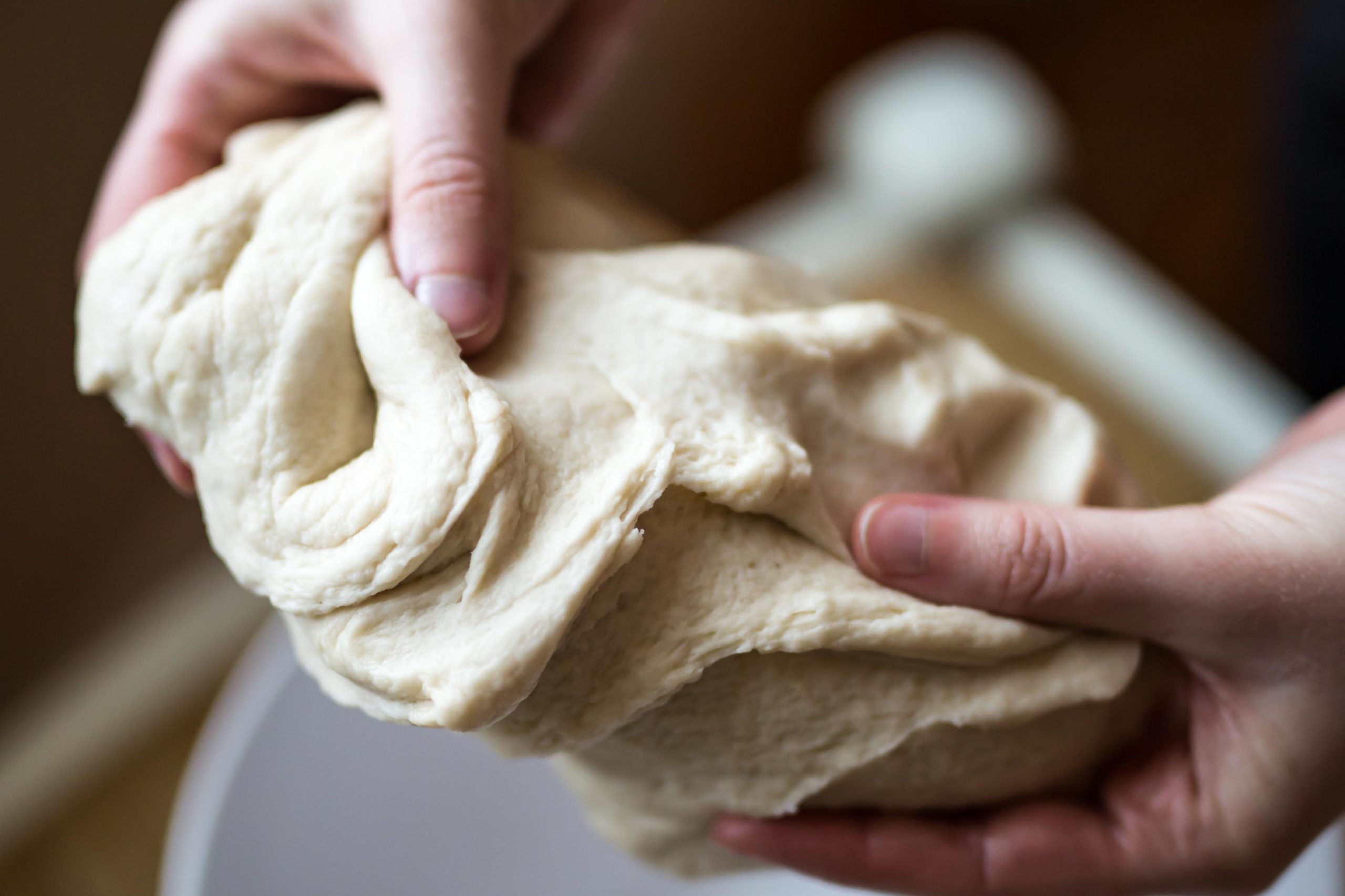A fun idea for kids at home. Child his kneading banana playdough in her fingers, over a bowl.