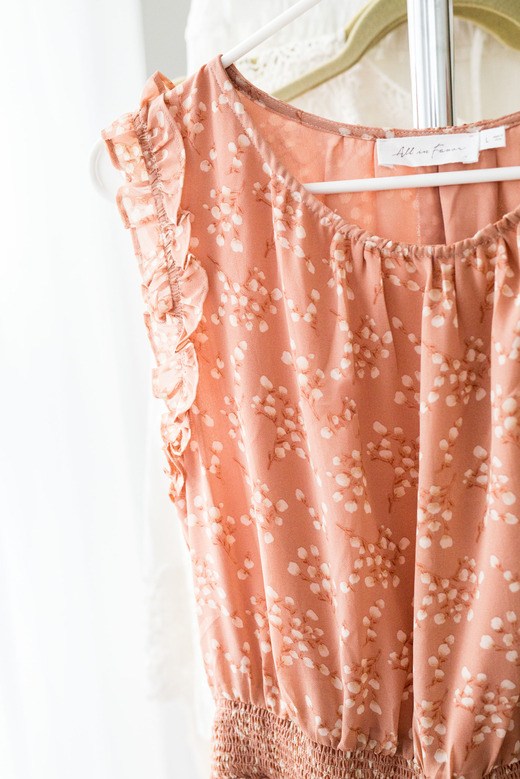 peach colored pretty dress with ruffles at shoulders.