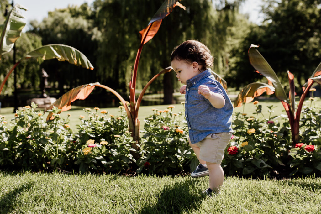 summer photo of toddler walking in grass
